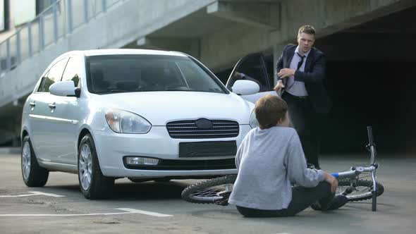 Male Driver Getting Out Car After Auto Crash With Teenager on Bicycle, Traffic