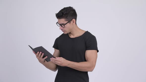 Happy Young Multi-ethnic Nerd Man Reading Book