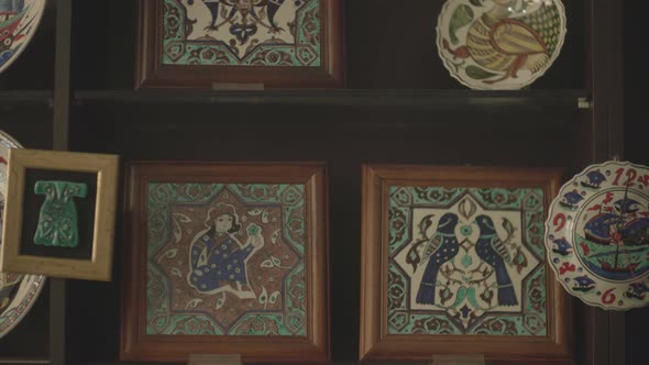 plates displayed in the window of a shop selling handmade ornamental plates