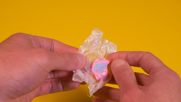 Opening A Piece Of Taffy Candy