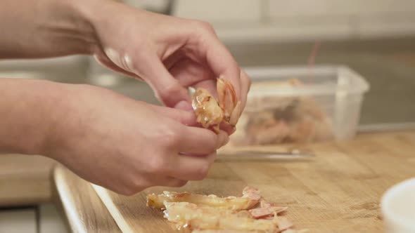 Female Hands Peeling Shrimps for Roasting