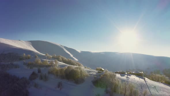 Old Ski Station on a Snowy Mountain Slope with a Lot of People on Skis and Snowboards