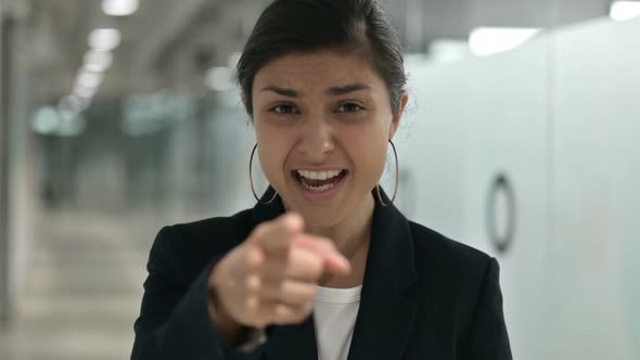 Portrait of Attractive Young Indian Businesswoman Pointing at the Camera