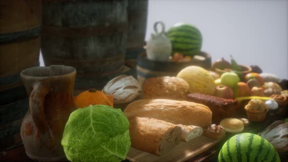 Food Table with Wine Barrels and Some Fruits Vegetables and Bread alt