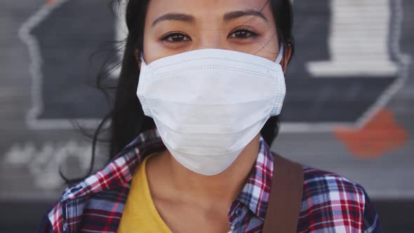 Woman wearing medical coronavirus mask looking at camera