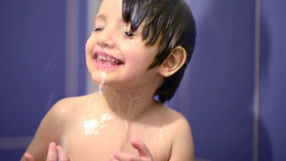 Happy Kid in Bathroom Playing with Water