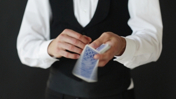 Magician Man Showing Trick With Playing Cards