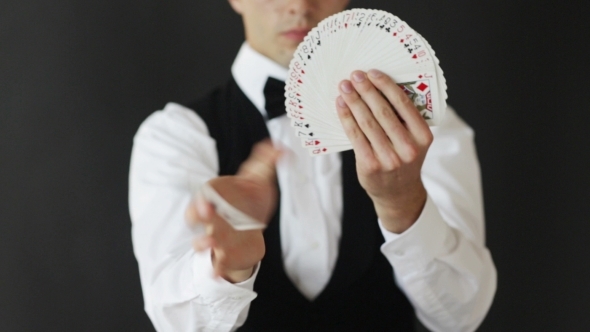Magician Man Showing Trick With Playing Cards