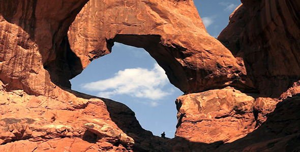 Hiker Climbs Rock Formation Celebrating Arms Out