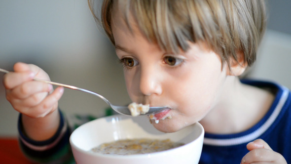 Boy Eating Cereal with Milk