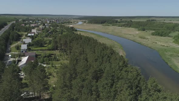 Aerial view of private houses in the forest next to the river 06