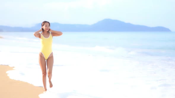 Asian woman enjoy around beautiful beach sea ocean