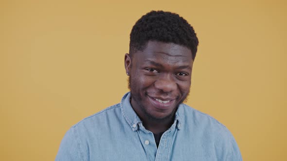 Attractive African American Man Smiling to the Camera Shaking His Head Touching Chin Horizontal