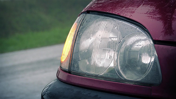 Car Light Flashing As Cars Pass In The Rain
