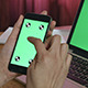 Girl Using Phone with Laptop Green Screen - VideoHive Item for Sale
