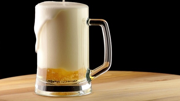 Light Beer is Poured into a Mug