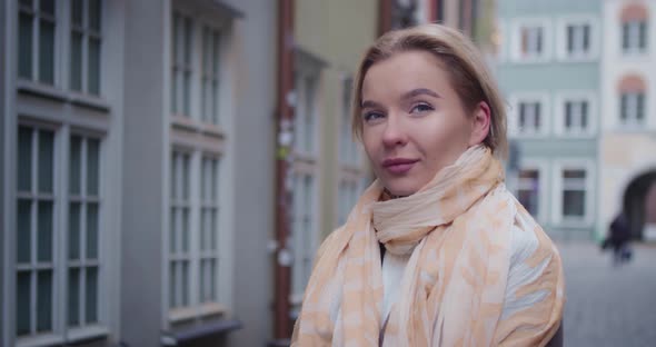 Portrait of a Pretty Girl Standing Among the Buildings