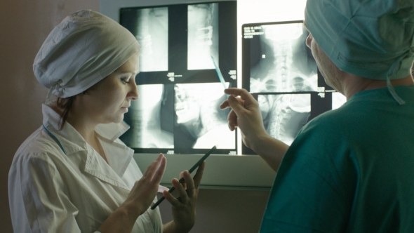 Nurse Writing Down Prescriptions Using Tablet PC