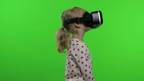 Child Girl Using VR Headset Helmet To Play Game. Watching Virtual Reality 3d 360 Video. Chroma Key