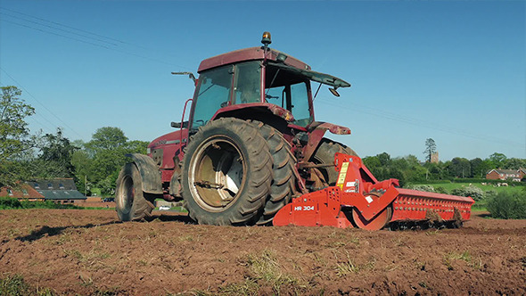 Tractor Passes By Ploughing Field