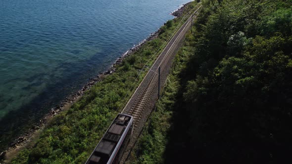 Drone Over Train Between Coast And Forest