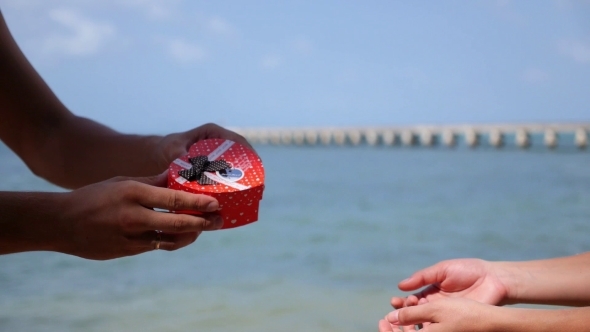 Man Hands Giving Red Gift Box To Girl