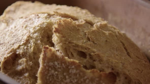 BAKING - Sourdough bread fresh from the oven, slow motion close up pan left