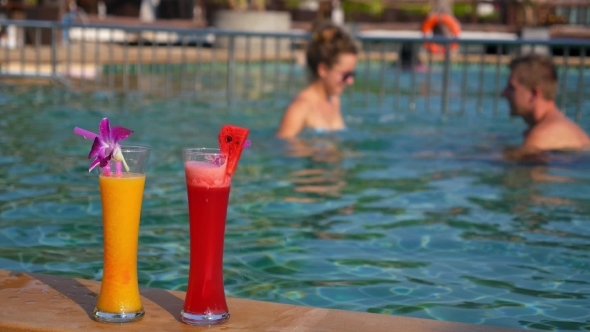 Happy Young Couple At The Swimming Pool In Summer