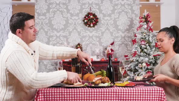 Caucasian Couple Eating and Enjoying Their Christmas Dinner