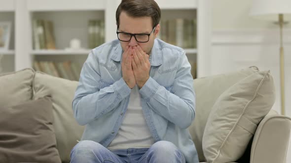 Sick Young Man Coughing at Home