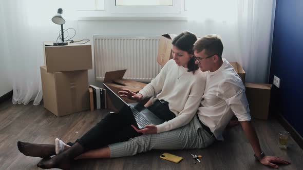 Happy Couple Relaxes After Moving in a New Home