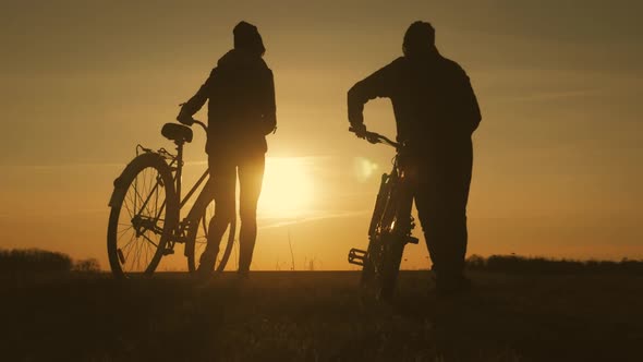 Couple Tourists Ride on Bike on the Road