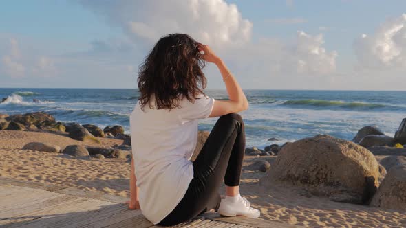 Woman on Beach at Beautiful Sunset, Looking at the Camera