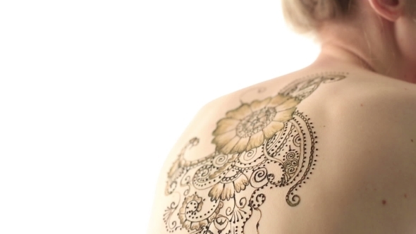 View Of Woman's Back With Beautiful Henna Pattern