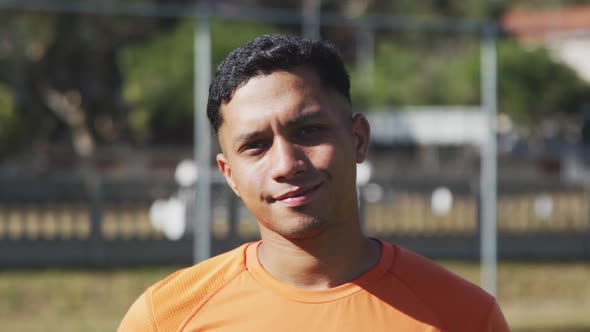 Soccer player smiling at camera on the field