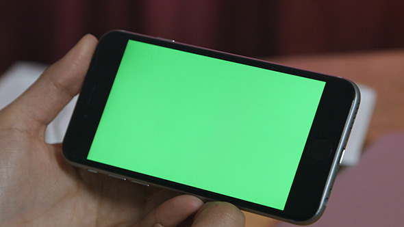Girl Holding Smartphone with Green Screen alt