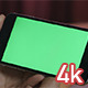 Girl Holding Smartphone with Green Screen - VideoHive Item for Sale