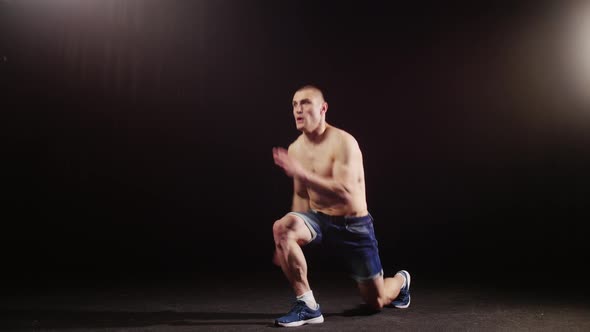 A Young Sports Man Warming Up His Whole Body