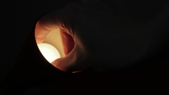 Screwing The Bulb In a Table Lamp In The Dark