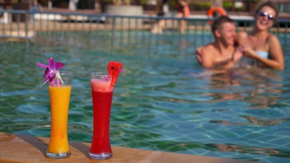 Happy Cheerful Couple In Swimming Pool In Hot