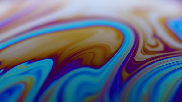 The Surface of the Liquid Soap with the Changing Colors of the Rainbow