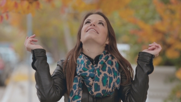 Beautiful Girl Standing Under Falling Leaves 