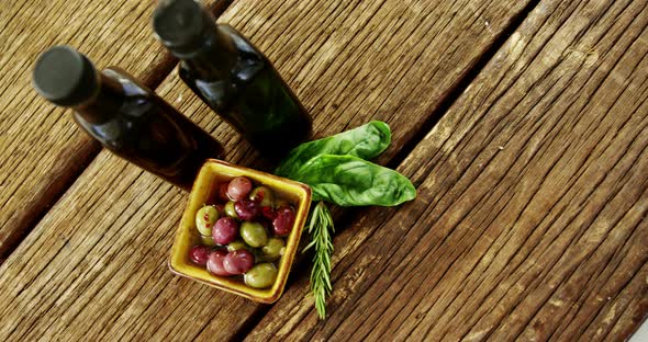 Olive oil bottles, herbs and bowl olives