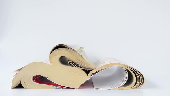 Strong wind caused the thick book that was placed on it to turn pages by itself.