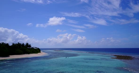 Luxury above abstract view of a white sandy paradise beach and blue water background in colorful 4K