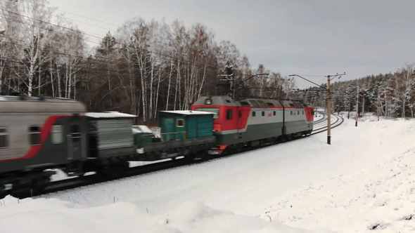 Freight Train Moving Through The Winter Forest
