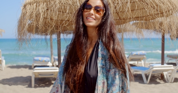 Cheerful Young Lady At The Beach Looking At Camera