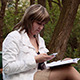 Girl Sitting in Park with Mobile Phone - VideoHive Item for Sale