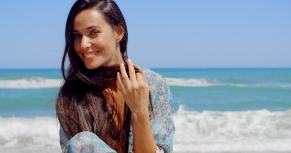 Happy Woman At The Beach Looking At Camera