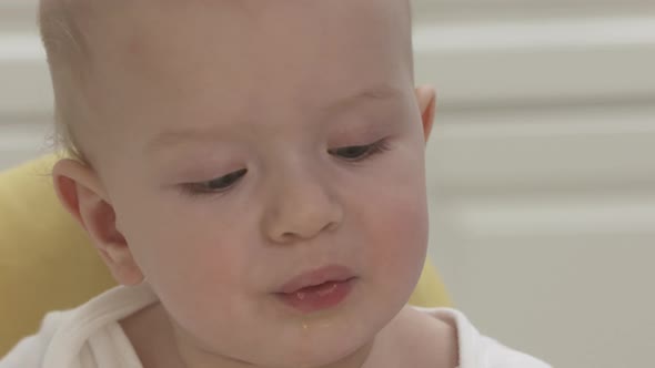 Baby Boy with Citrus Fruit Sitting on High Chair for Babies Oneyearold Baby Boy Eating Tangerine